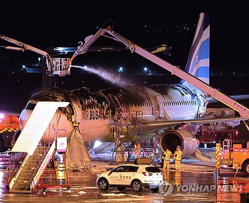 28일 김해공항 계류장에서 승객 170명과 승무원 6명을 태우고 이륙을 준비하던 홍콩행 에어부산 항공기 BX391편 내부에서 불이 나 소방대원들이 진화 작업을 하고 있다. 화재는 1시간 16분 만에 완전히 진압됐고, 승객 170명, 승무원 6명 등 모두 176명이 비상 슬라이드로 모두 탈출했다. [부산=연합뉴스]